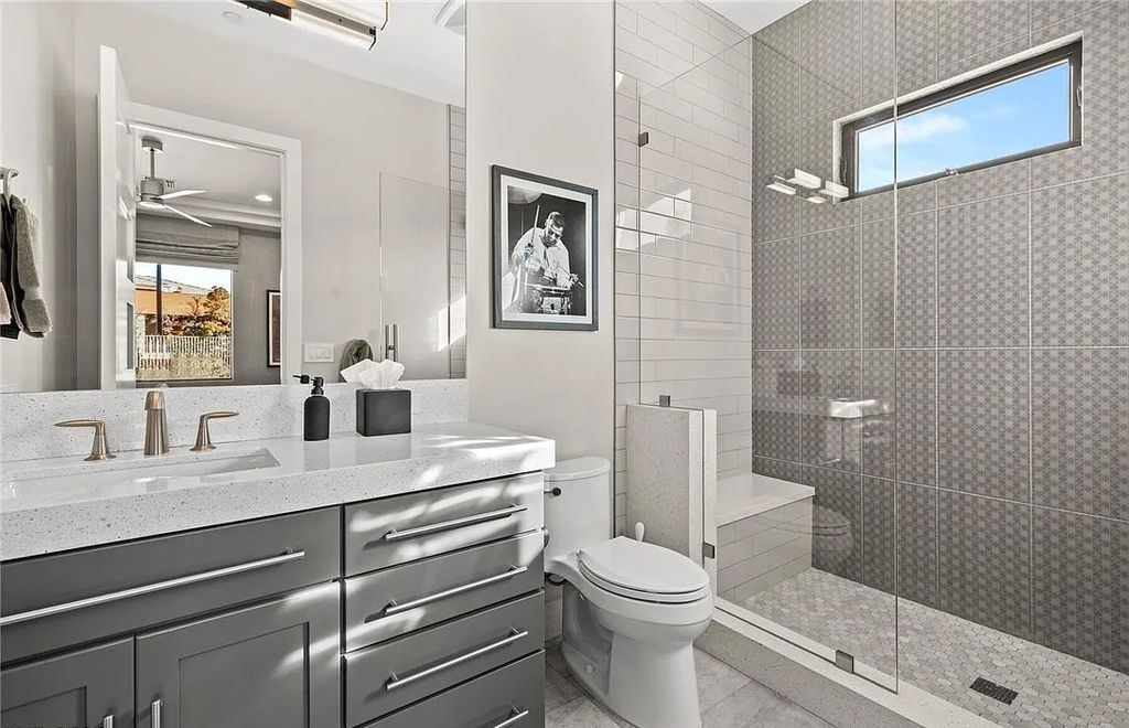 20 Skybird Court, Las Vegas, Nevada is a fully remodeled gem in the enclave of Redhawk behind the guard gates of The Ridges boasting a basketball area, pool with water slide and oversized wet deck, an indoor/outdoor bar, firepit, outdoor kitchen with ceiling mounted infrared heaters, and a wine cellar.