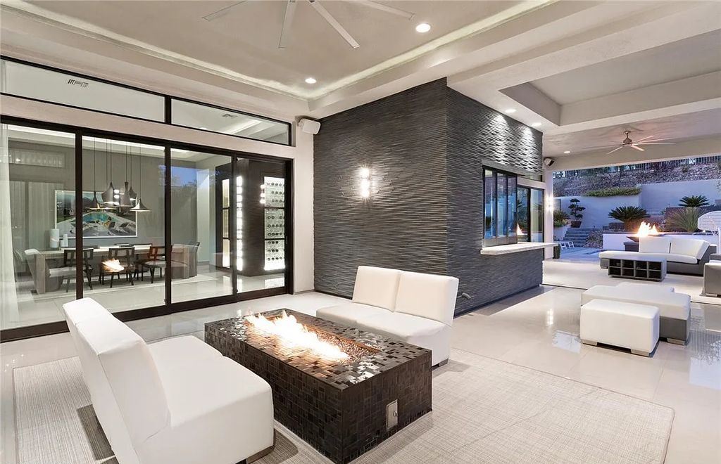 20 Skybird Court, Las Vegas, Nevada is a fully remodeled gem in the enclave of Redhawk behind the guard gates of The Ridges boasting a basketball area, pool with water slide and oversized wet deck, an indoor/outdoor bar, firepit, outdoor kitchen with ceiling mounted infrared heaters, and a wine cellar.