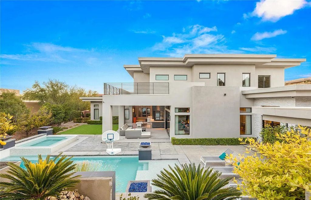 20 Skybird Court, Las Vegas, Nevada is a fully remodeled gem in the enclave of Redhawk behind the guard gates of The Ridges boasting a basketball area, pool with water slide and oversized wet deck, an indoor/outdoor bar, firepit, outdoor kitchen with ceiling mounted infrared heaters, and a wine cellar.