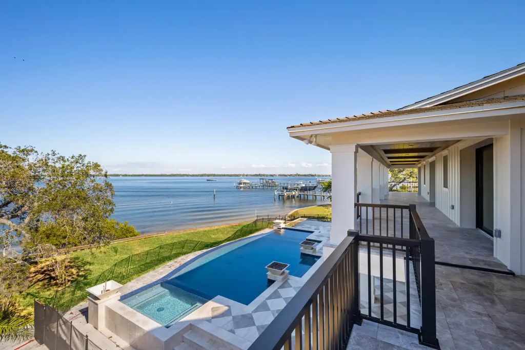 7814 Desoto Memorial Highway, Bradenton, Florida is an elegant Cape Cod styled manor was rebuilt in 2022 by Gagne Construction Idyllically poised at the mouth of the Manatee River, enjoy the natural beauty and spectacular water views.