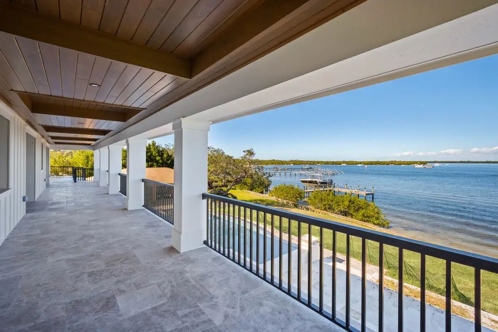7814 Desoto Memorial Highway, Bradenton, Florida is an elegant Cape Cod styled manor was rebuilt in 2022 by Gagne Construction Idyllically poised at the mouth of the Manatee River, enjoy the natural beauty and spectacular water views.