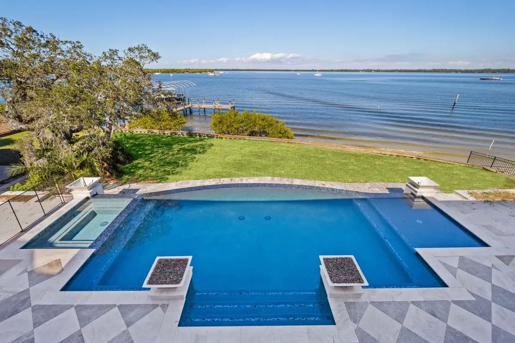 7814 Desoto Memorial Highway, Bradenton, Florida is an elegant Cape Cod styled manor was rebuilt in 2022 by Gagne Construction Idyllically poised at the mouth of the Manatee River, enjoy the natural beauty and spectacular water views.