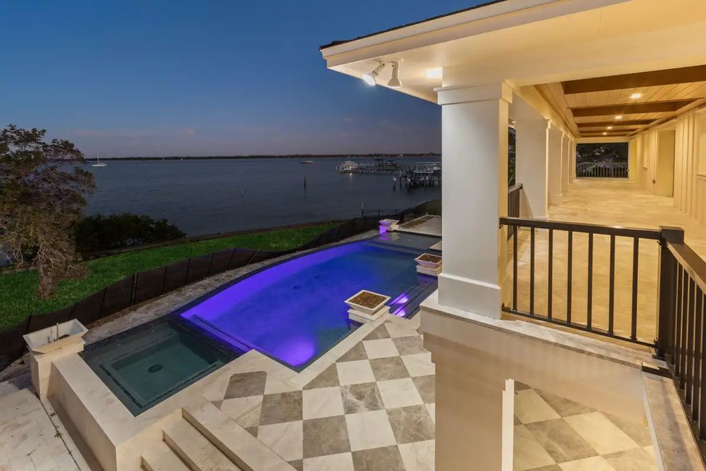 7814 Desoto Memorial Highway, Bradenton, Florida is an elegant Cape Cod styled manor was rebuilt in 2022 by Gagne Construction Idyllically poised at the mouth of the Manatee River, enjoy the natural beauty and spectacular water views.