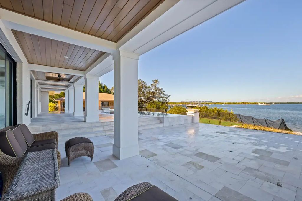 7814 Desoto Memorial Highway, Bradenton, Florida is an elegant Cape Cod styled manor was rebuilt in 2022 by Gagne Construction Idyllically poised at the mouth of the Manatee River, enjoy the natural beauty and spectacular water views.