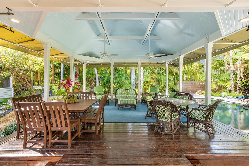 101 Admirals Lane, Key West, Florida,  provides privacy and a lush atmosphere for this remarkable home on a huge 14,000 SF lot, surrounded by a wall of tropical foliage. It is a spectacular property on one of the largest lots in the gated community of Truman Annex, featuring three separate dwellings blending traditional and contemporary architecture.