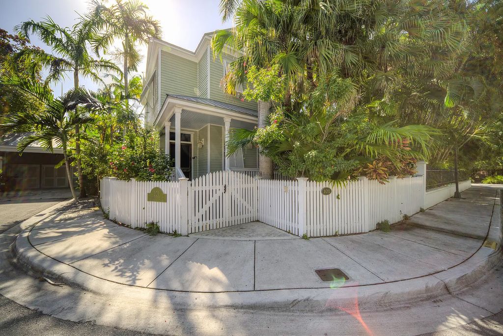101 Admirals Lane, Key West, Florida,  provides privacy and a lush atmosphere for this remarkable home on a huge 14,000 SF lot, surrounded by a wall of tropical foliage. It is a spectacular property on one of the largest lots in the gated community of Truman Annex, featuring three separate dwellings blending traditional and contemporary architecture.