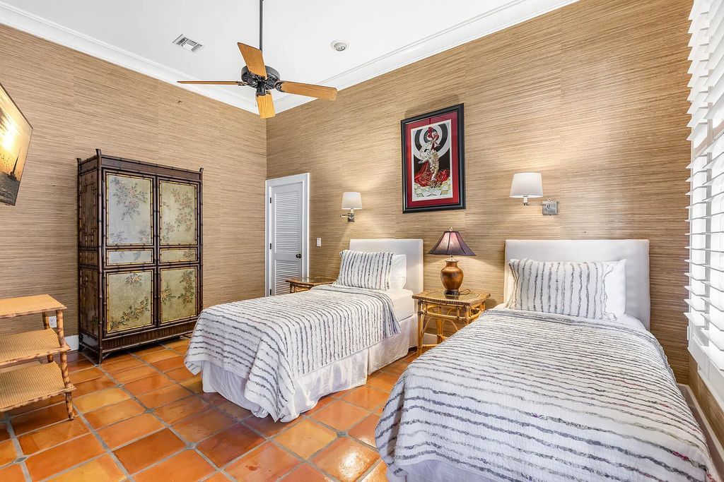 101 Admirals Lane, Key West, Florida,  provides privacy and a lush atmosphere for this remarkable home on a huge 14,000 SF lot, surrounded by a wall of tropical foliage. It is a spectacular property on one of the largest lots in the gated community of Truman Annex, featuring three separate dwellings blending traditional and contemporary architecture.