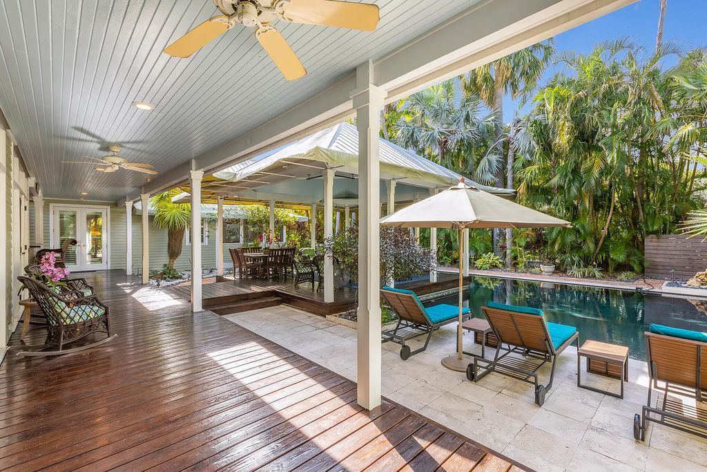 101 Admirals Lane, Key West, Florida,  provides privacy and a lush atmosphere for this remarkable home on a huge 14,000 SF lot, surrounded by a wall of tropical foliage. It is a spectacular property on one of the largest lots in the gated community of Truman Annex, featuring three separate dwellings blending traditional and contemporary architecture.