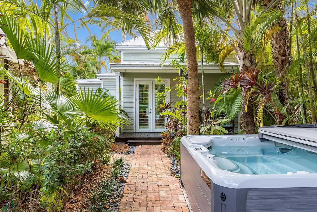 101 Admirals Lane, Key West, Florida,  provides privacy and a lush atmosphere for this remarkable home on a huge 14,000 SF lot, surrounded by a wall of tropical foliage. It is a spectacular property on one of the largest lots in the gated community of Truman Annex, featuring three separate dwellings blending traditional and contemporary architecture.