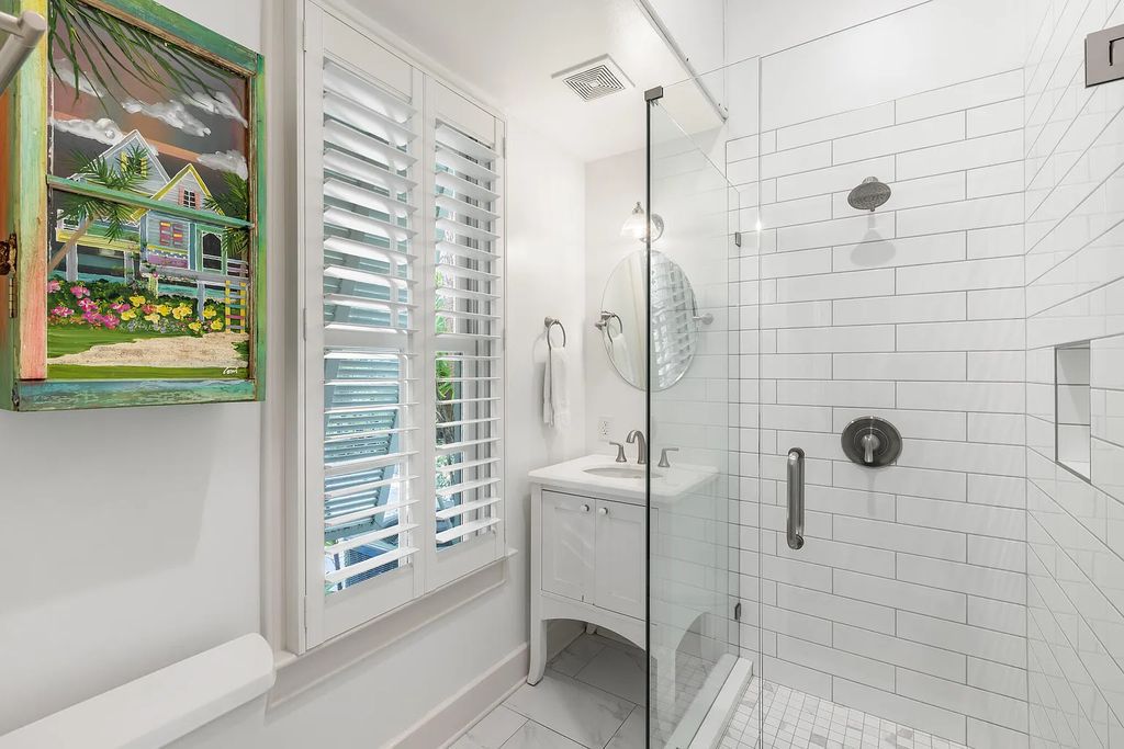 101 Admirals Lane, Key West, Florida,  provides privacy and a lush atmosphere for this remarkable home on a huge 14,000 SF lot, surrounded by a wall of tropical foliage. It is a spectacular property on one of the largest lots in the gated community of Truman Annex, featuring three separate dwellings blending traditional and contemporary architecture.