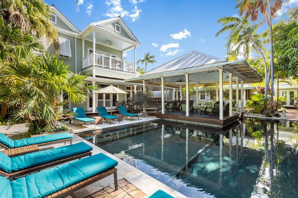 101 Admirals Lane, Key West, Florida,  provides privacy and a lush atmosphere for this remarkable home on a huge 14,000 SF lot, surrounded by a wall of tropical foliage. It is a spectacular property on one of the largest lots in the gated community of Truman Annex, featuring three separate dwellings blending traditional and contemporary architecture.