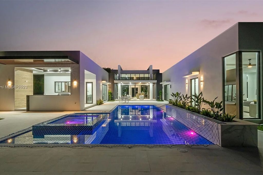 9765 SW 110th Street, Miami, Florida is an exquisite modern new construction built among stately palms and mature oak trees on a quiet cul-de-sac, experience the ultimate South Florida lifestyle lounging around the 38' pool with spa and 3 beaches.