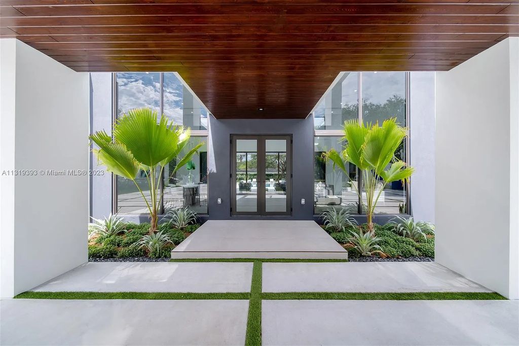 9765 SW 110th Street, Miami, Florida is an exquisite modern new construction built among stately palms and mature oak trees on a quiet cul-de-sac, experience the ultimate South Florida lifestyle lounging around the 38' pool with spa and 3 beaches.