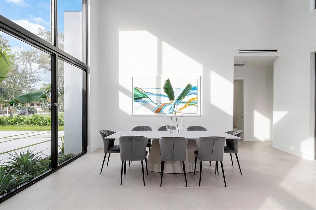 9765 SW 110th Street, Miami, Florida is an exquisite modern new construction built among stately palms and mature oak trees on a quiet cul-de-sac, experience the ultimate South Florida lifestyle lounging around the 38' pool with spa and 3 beaches.