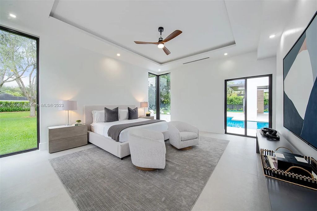 9765 SW 110th Street, Miami, Florida is an exquisite modern new construction built among stately palms and mature oak trees on a quiet cul-de-sac, experience the ultimate South Florida lifestyle lounging around the 38' pool with spa and 3 beaches.