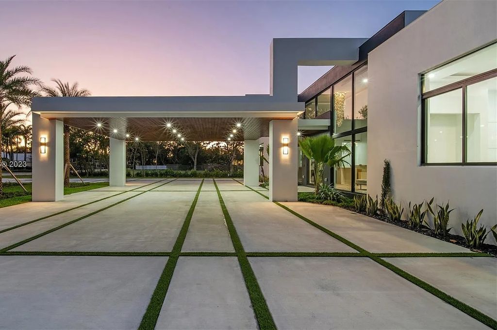 9765 SW 110th Street, Miami, Florida is an exquisite modern new construction built among stately palms and mature oak trees on a quiet cul-de-sac, experience the ultimate South Florida lifestyle lounging around the 38' pool with spa and 3 beaches.