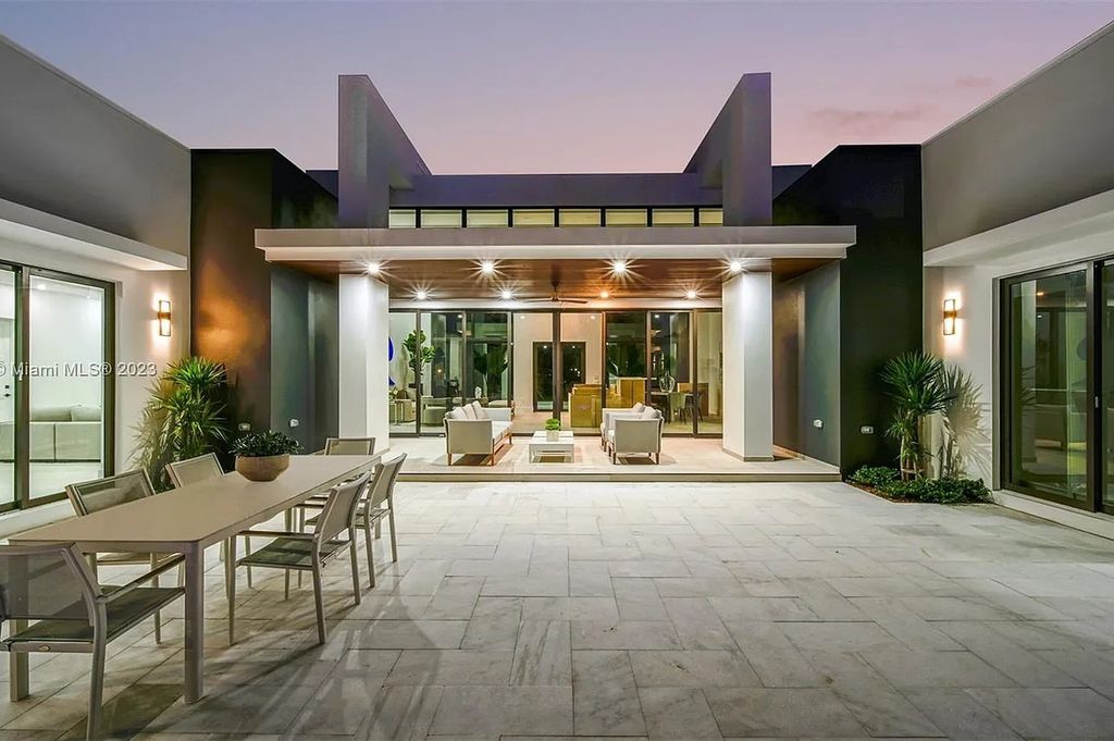 9765 SW 110th Street, Miami, Florida is an exquisite modern new construction built among stately palms and mature oak trees on a quiet cul-de-sac, experience the ultimate South Florida lifestyle lounging around the 38' pool with spa and 3 beaches.