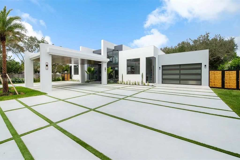 9765 SW 110th Street, Miami, Florida is an exquisite modern new construction built among stately palms and mature oak trees on a quiet cul-de-sac, experience the ultimate South Florida lifestyle lounging around the 38' pool with spa and 3 beaches.