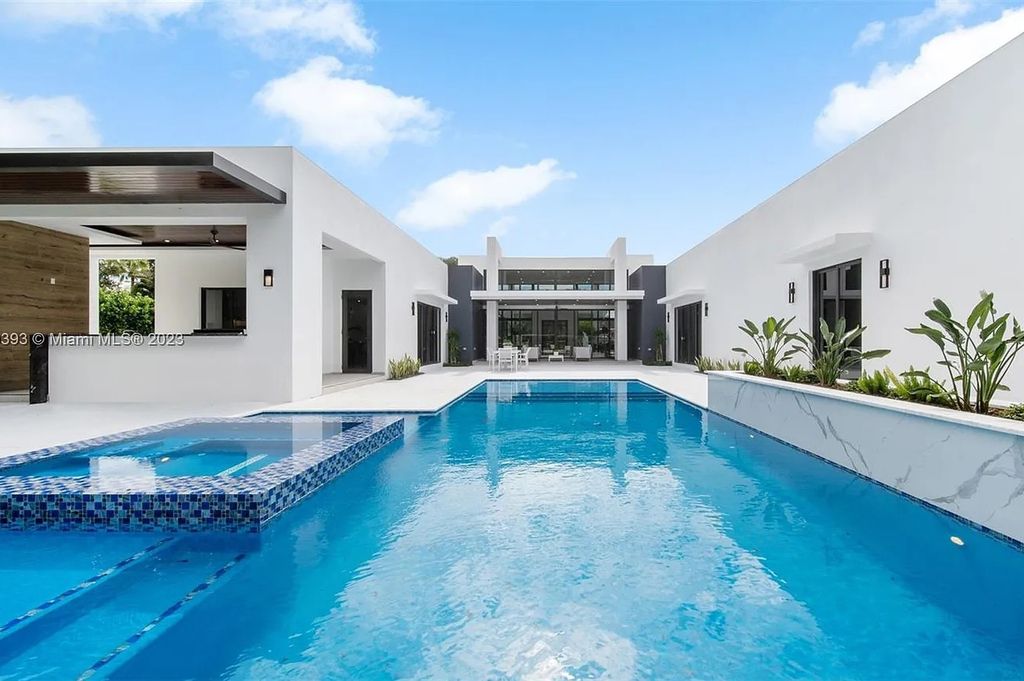 9765 SW 110th Street, Miami, Florida is an exquisite modern new construction built among stately palms and mature oak trees on a quiet cul-de-sac, experience the ultimate South Florida lifestyle lounging around the 38' pool with spa and 3 beaches.