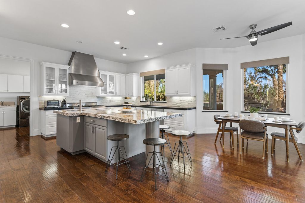 2000 Bogart Court, Las Vegas, Nevada is a one of a kind home situated on a cul-de-sac inside a private gated community featuring stunning finishes throughout with Limestone and hardwood flooring, quartzite fireplace, motorized window shades and grand 24” foot ceilings.