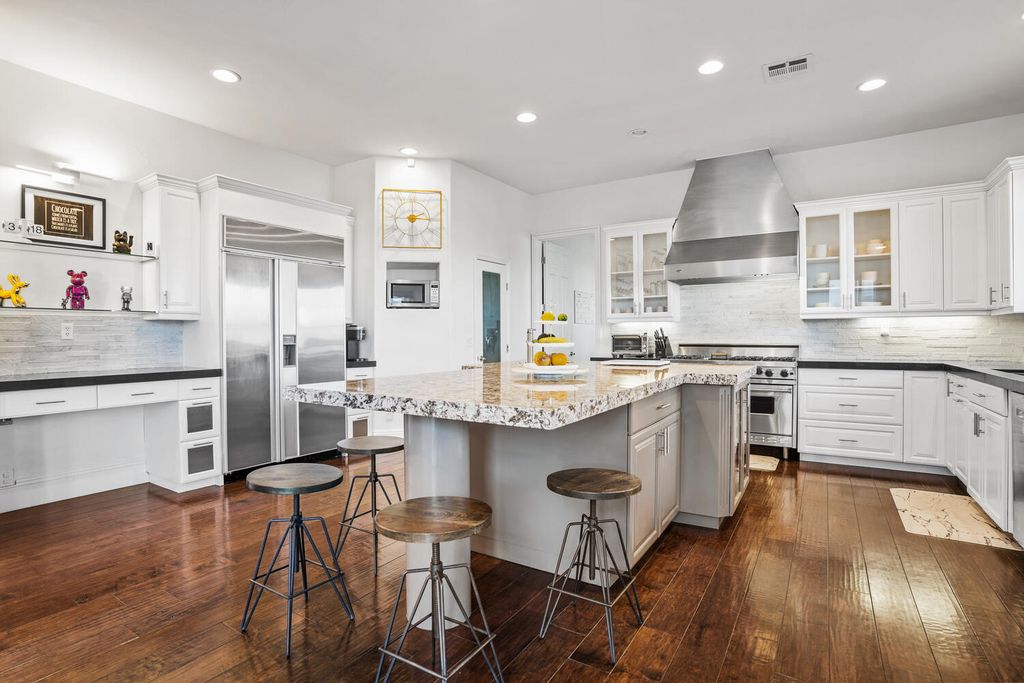 2000 Bogart Court, Las Vegas, Nevada is a one of a kind home situated on a cul-de-sac inside a private gated community featuring stunning finishes throughout with Limestone and hardwood flooring, quartzite fireplace, motorized window shades and grand 24” foot ceilings.