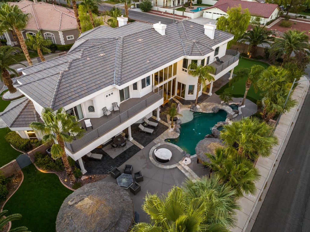 2000 Bogart Court, Las Vegas, Nevada is a one of a kind home situated on a cul-de-sac inside a private gated community featuring stunning finishes throughout with Limestone and hardwood flooring, quartzite fireplace, motorized window shades and grand 24” foot ceilings.