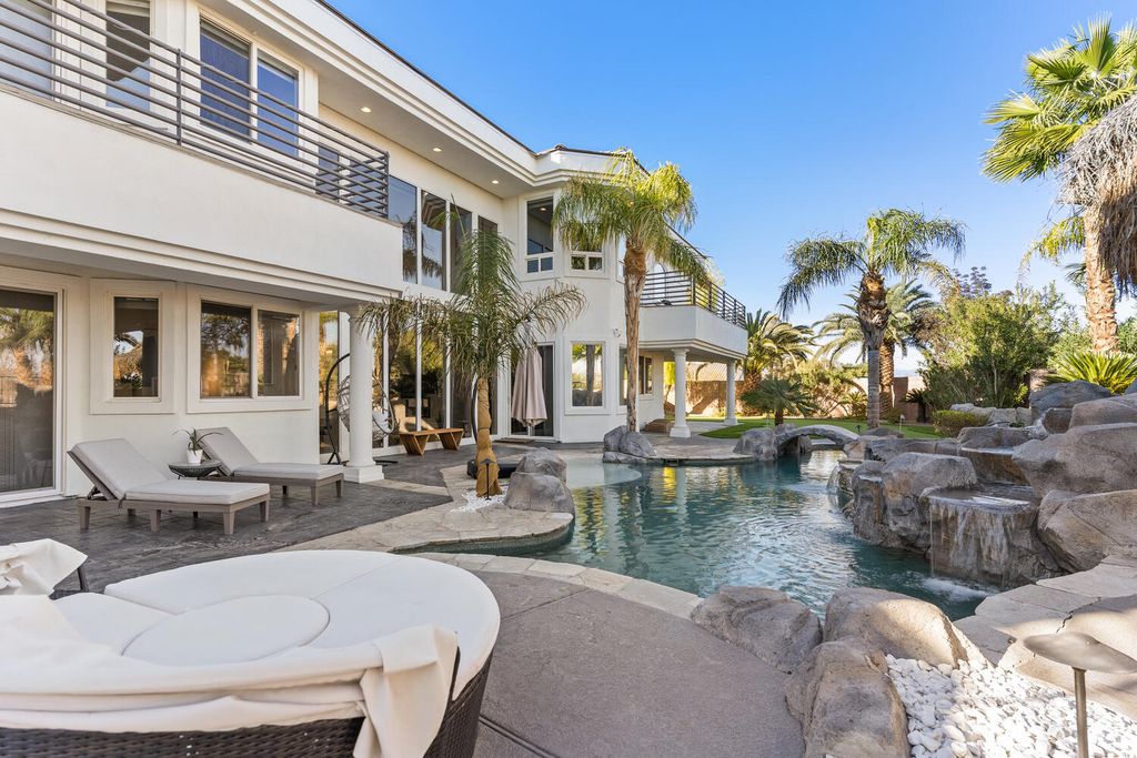 2000 Bogart Court, Las Vegas, Nevada is a one of a kind home situated on a cul-de-sac inside a private gated community featuring stunning finishes throughout with Limestone and hardwood flooring, quartzite fireplace, motorized window shades and grand 24” foot ceilings.