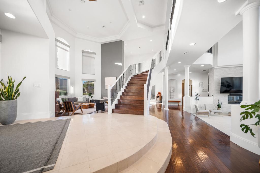 2000 Bogart Court, Las Vegas, Nevada is a one of a kind home situated on a cul-de-sac inside a private gated community featuring stunning finishes throughout with Limestone and hardwood flooring, quartzite fireplace, motorized window shades and grand 24” foot ceilings.