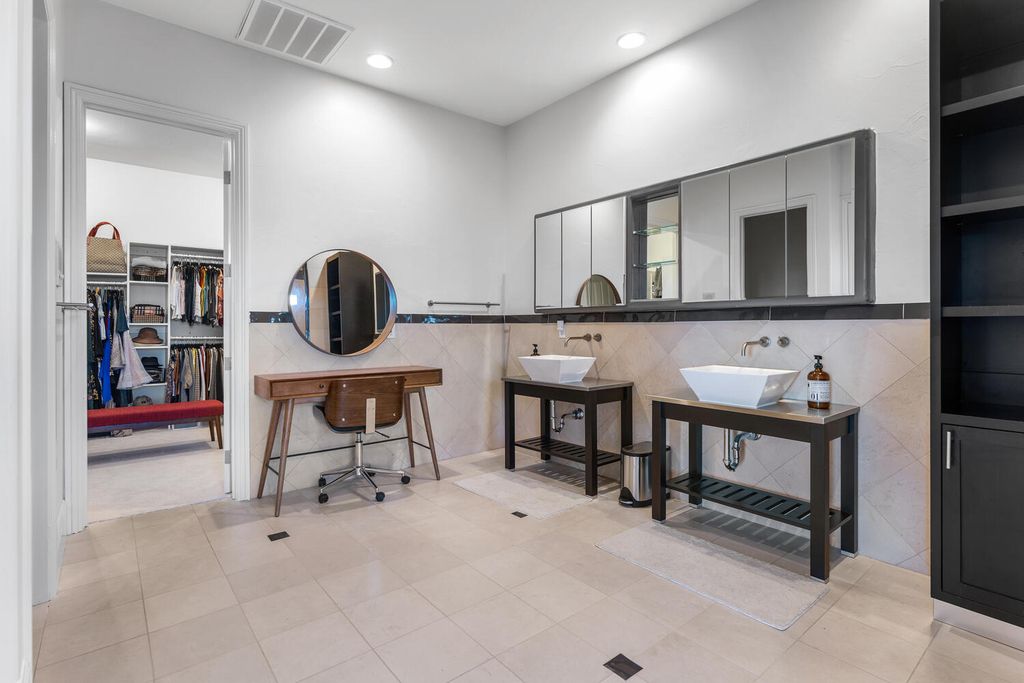 2000 Bogart Court, Las Vegas, Nevada is a one of a kind home situated on a cul-de-sac inside a private gated community featuring stunning finishes throughout with Limestone and hardwood flooring, quartzite fireplace, motorized window shades and grand 24” foot ceilings.