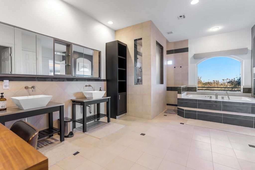 2000 Bogart Court, Las Vegas, Nevada is a one of a kind home situated on a cul-de-sac inside a private gated community featuring stunning finishes throughout with Limestone and hardwood flooring, quartzite fireplace, motorized window shades and grand 24” foot ceilings.