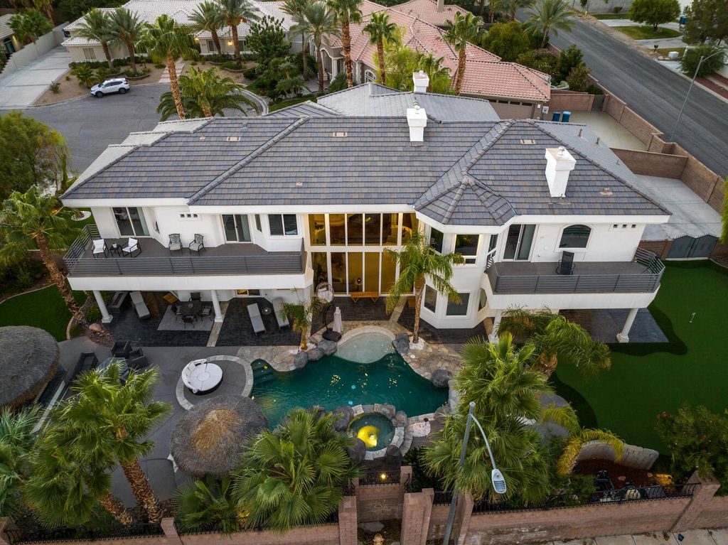 2000 Bogart Court, Las Vegas, Nevada is a one of a kind home situated on a cul-de-sac inside a private gated community featuring stunning finishes throughout with Limestone and hardwood flooring, quartzite fireplace, motorized window shades and grand 24” foot ceilings.