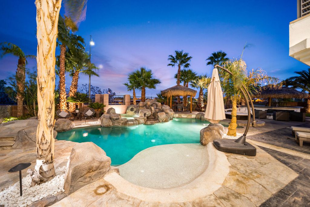 2000 Bogart Court, Las Vegas, Nevada is a one of a kind home situated on a cul-de-sac inside a private gated community featuring stunning finishes throughout with Limestone and hardwood flooring, quartzite fireplace, motorized window shades and grand 24” foot ceilings.