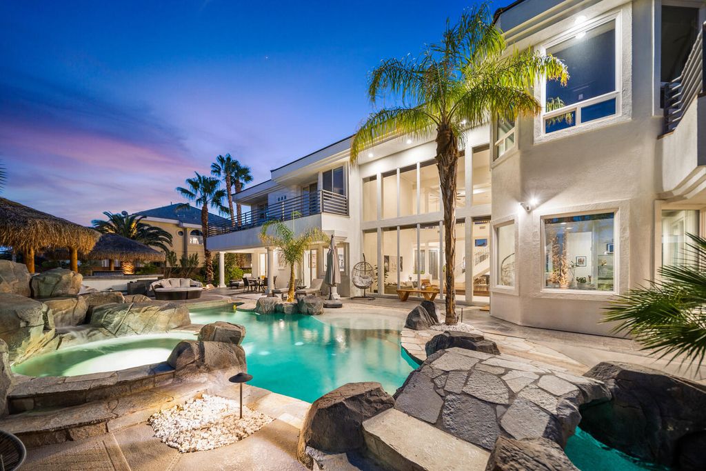 2000 Bogart Court, Las Vegas, Nevada is a one of a kind home situated on a cul-de-sac inside a private gated community featuring stunning finishes throughout with Limestone and hardwood flooring, quartzite fireplace, motorized window shades and grand 24” foot ceilings.