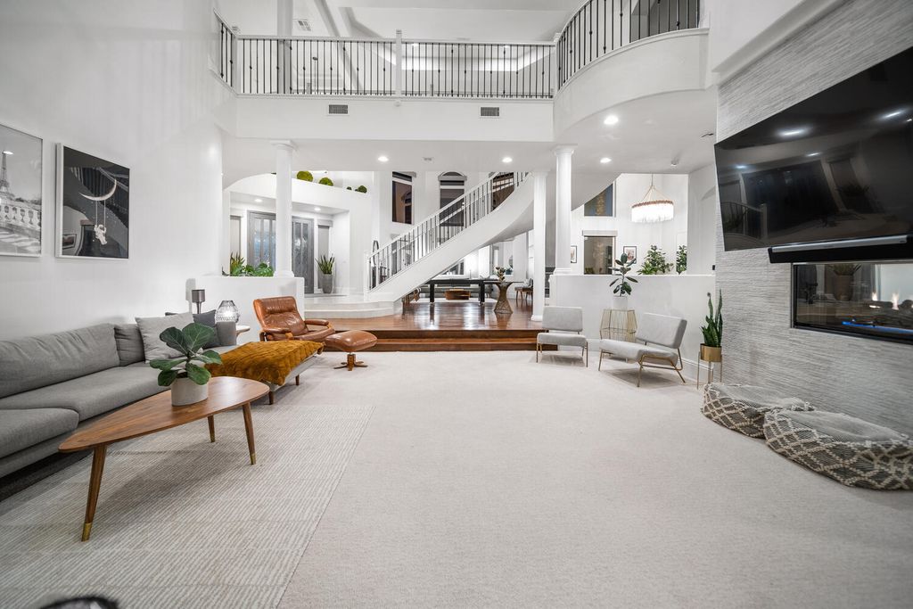2000 Bogart Court, Las Vegas, Nevada is a one of a kind home situated on a cul-de-sac inside a private gated community featuring stunning finishes throughout with Limestone and hardwood flooring, quartzite fireplace, motorized window shades and grand 24” foot ceilings.