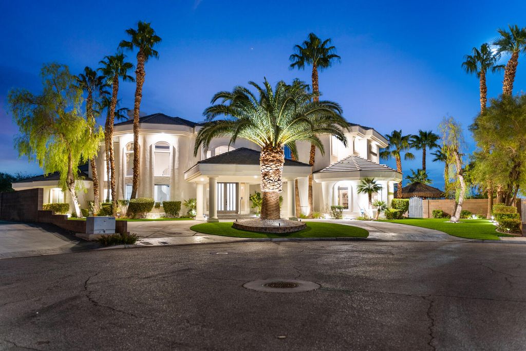 2000 Bogart Court, Las Vegas, Nevada is a one of a kind home situated on a cul-de-sac inside a private gated community featuring stunning finishes throughout with Limestone and hardwood flooring, quartzite fireplace, motorized window shades and grand 24” foot ceilings.