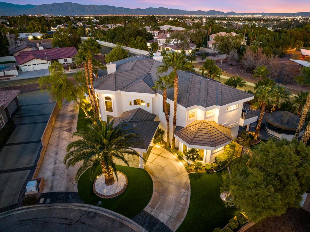 2000 Bogart Court, Las Vegas, Nevada is a one of a kind home situated on a cul-de-sac inside a private gated community featuring stunning finishes throughout with Limestone and hardwood flooring, quartzite fireplace, motorized window shades and grand 24” foot ceilings.