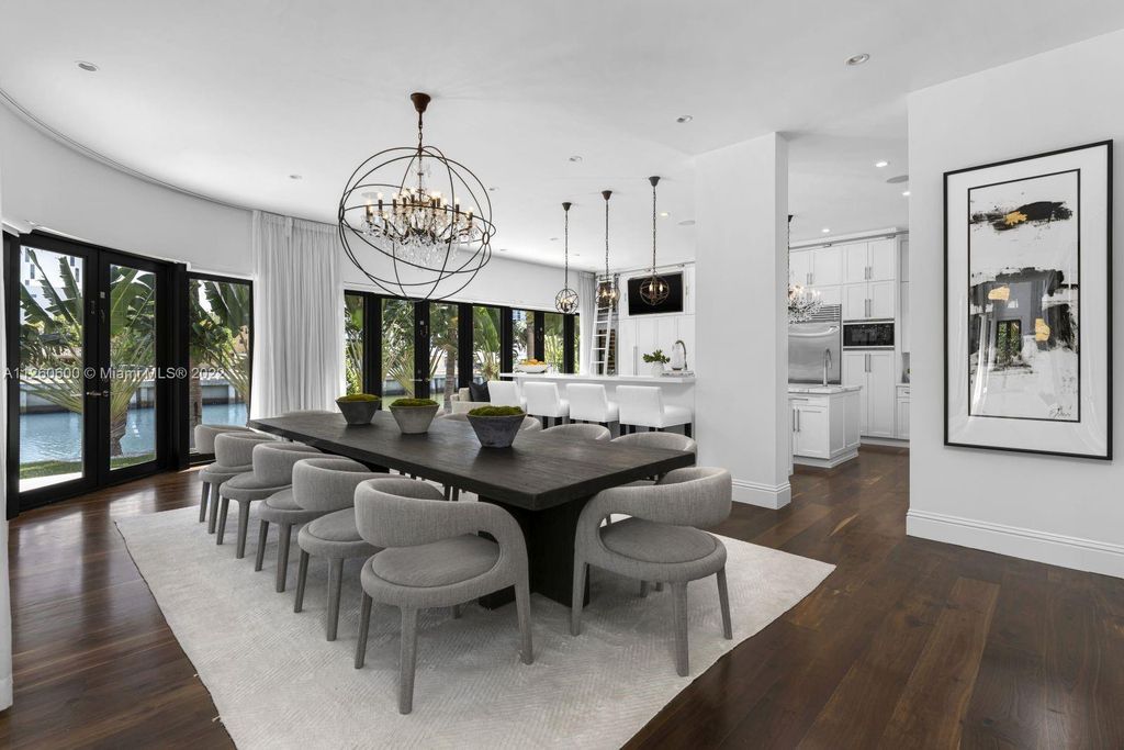 2901 Flamingo Drive, Miami Beach, Florida is named La Joya with 300 foot of water in most vibrant neighborhood on Miami Beach, features include dramatic master + sitting rm. 13ft ceilings, wall of glass, + 3 terraces. 4 beds up 1 down+ office/library. 1 bd, 1 and a half bath guest villa with private patio, 2 car garage, private gated entry court.
