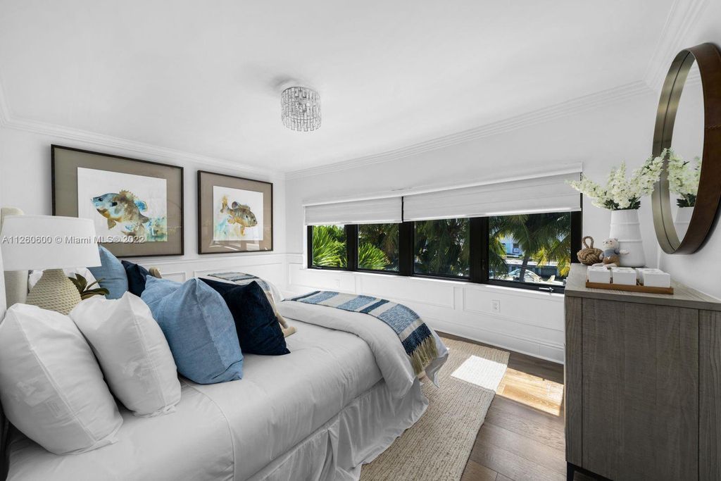 2901 Flamingo Drive, Miami Beach, Florida is named La Joya with 300 foot of water in most vibrant neighborhood on Miami Beach, features include dramatic master + sitting rm. 13ft ceilings, wall of glass, + 3 terraces. 4 beds up 1 down+ office/library. 1 bd, 1 and a half bath guest villa with private patio, 2 car garage, private gated entry court.