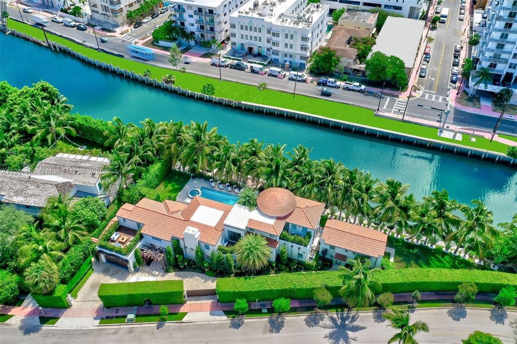 2901 Flamingo Drive, Miami Beach, Florida is named La Joya with 300 foot of water in most vibrant neighborhood on Miami Beach, features include dramatic master + sitting rm. 13ft ceilings, wall of glass, + 3 terraces. 4 beds up 1 down+ office/library. 1 bd, 1 and a half bath guest villa with private patio, 2 car garage, private gated entry court.