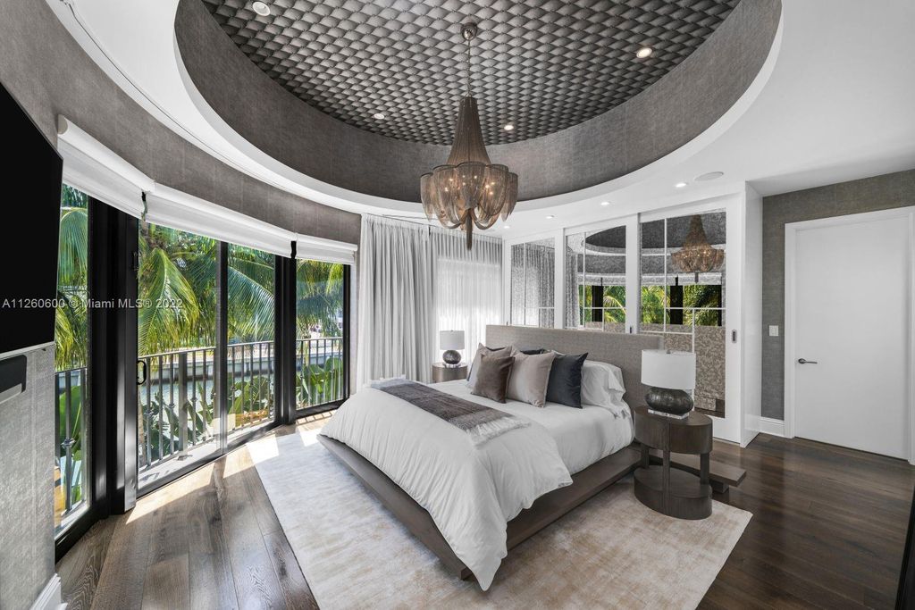 2901 Flamingo Drive, Miami Beach, Florida is named La Joya with 300 foot of water in most vibrant neighborhood on Miami Beach, features include dramatic master + sitting rm. 13ft ceilings, wall of glass, + 3 terraces. 4 beds up 1 down+ office/library. 1 bd, 1 and a half bath guest villa with private patio, 2 car garage, private gated entry court.