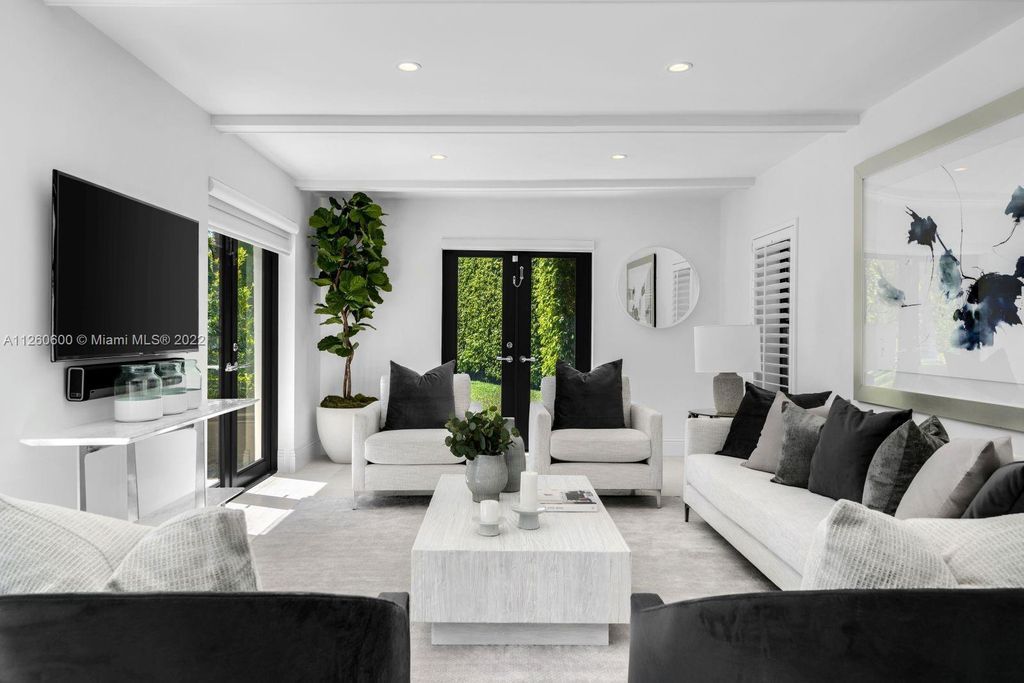 2901 Flamingo Drive, Miami Beach, Florida is named La Joya with 300 foot of water in most vibrant neighborhood on Miami Beach, features include dramatic master + sitting rm. 13ft ceilings, wall of glass, + 3 terraces. 4 beds up 1 down+ office/library. 1 bd, 1 and a half bath guest villa with private patio, 2 car garage, private gated entry court.