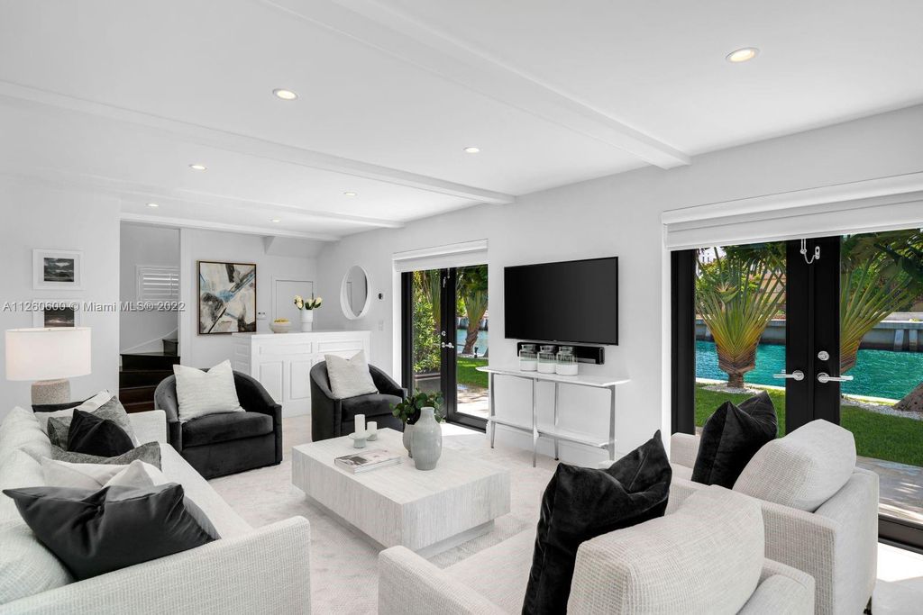 2901 Flamingo Drive, Miami Beach, Florida is named La Joya with 300 foot of water in most vibrant neighborhood on Miami Beach, features include dramatic master + sitting rm. 13ft ceilings, wall of glass, + 3 terraces. 4 beds up 1 down+ office/library. 1 bd, 1 and a half bath guest villa with private patio, 2 car garage, private gated entry court.