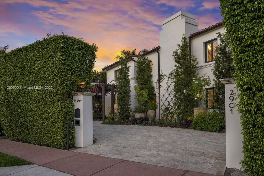 2901 Flamingo Drive, Miami Beach, Florida is named La Joya with 300 foot of water in most vibrant neighborhood on Miami Beach, features include dramatic master + sitting rm. 13ft ceilings, wall of glass, + 3 terraces. 4 beds up 1 down+ office/library. 1 bd, 1 and a half bath guest villa with private patio, 2 car garage, private gated entry court.