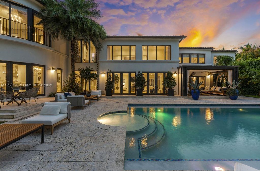 2901 Flamingo Drive, Miami Beach, Florida is named La Joya with 300 foot of water in most vibrant neighborhood on Miami Beach, features include dramatic master + sitting rm. 13ft ceilings, wall of glass, + 3 terraces. 4 beds up 1 down+ office/library. 1 bd, 1 and a half bath guest villa with private patio, 2 car garage, private gated entry court.