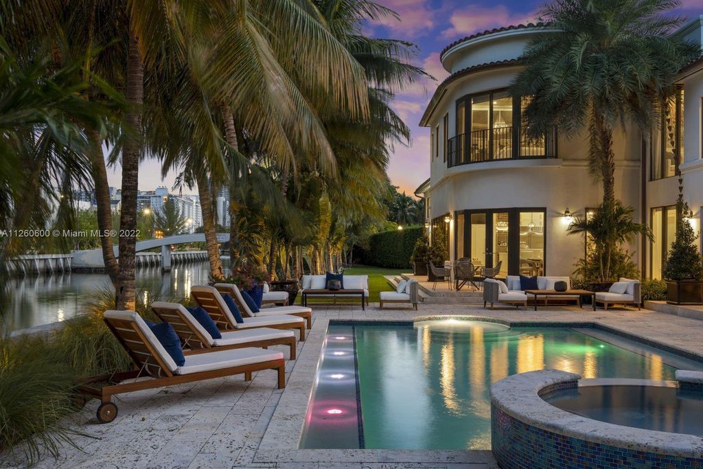 2901 Flamingo Drive, Miami Beach, Florida is named La Joya with 300 foot of water in most vibrant neighborhood on Miami Beach, features include dramatic master + sitting rm. 13ft ceilings, wall of glass, + 3 terraces. 4 beds up 1 down+ office/library. 1 bd, 1 and a half bath guest villa with private patio, 2 car garage, private gated entry court.