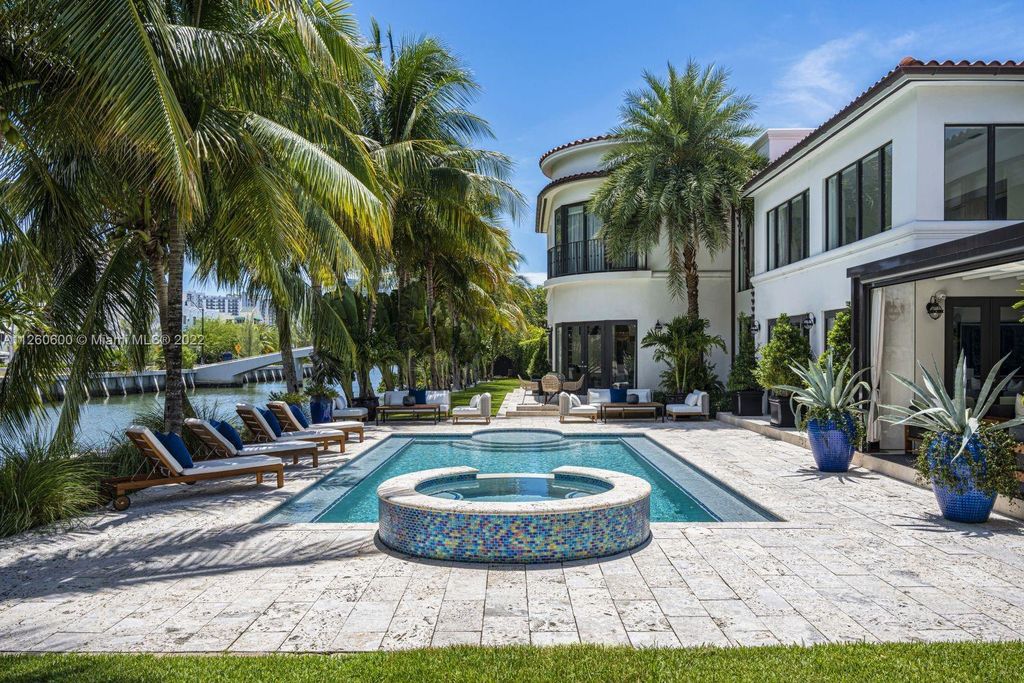 2901 Flamingo Drive, Miami Beach, Florida is named La Joya with 300 foot of water in most vibrant neighborhood on Miami Beach, features include dramatic master + sitting rm. 13ft ceilings, wall of glass, + 3 terraces. 4 beds up 1 down+ office/library. 1 bd, 1 and a half bath guest villa with private patio, 2 car garage, private gated entry court.