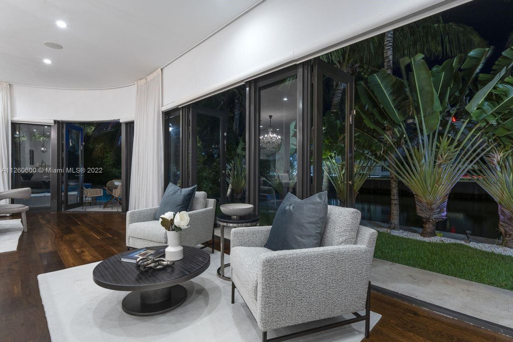 2901 Flamingo Drive, Miami Beach, Florida is named La Joya with 300 foot of water in most vibrant neighborhood on Miami Beach, features include dramatic master + sitting rm. 13ft ceilings, wall of glass, + 3 terraces. 4 beds up 1 down+ office/library. 1 bd, 1 and a half bath guest villa with private patio, 2 car garage, private gated entry court.