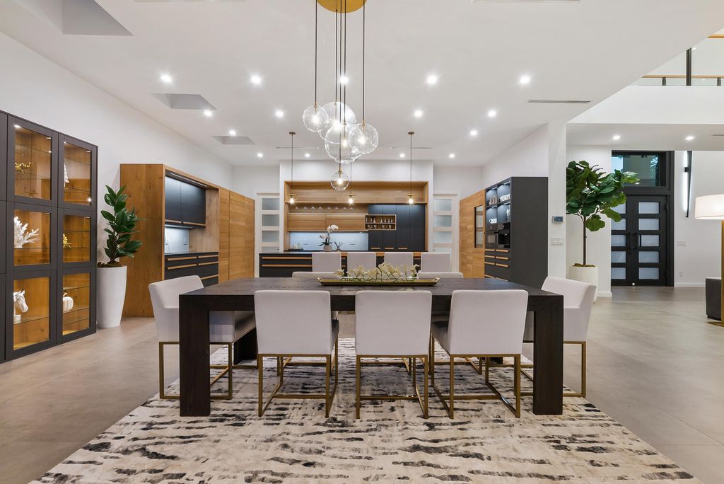 545 Kingfisher Lane, Longboat Key, Florida is a custom built modern canal front Longboat Key home with dramatic wide shell stone stair entrance, massive 60-inch ceramic tile flooring, 20-foot ceilings, skylights, lap-pool with 2 waterfall features, outdoor kitchen adjacent to indoor kitchen, and 5-car garage.