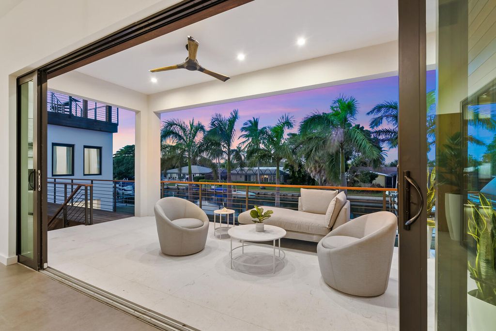 545 Kingfisher Lane, Longboat Key, Florida is a custom built modern canal front Longboat Key home with dramatic wide shell stone stair entrance, massive 60-inch ceramic tile flooring, 20-foot ceilings, skylights, lap-pool with 2 waterfall features, outdoor kitchen adjacent to indoor kitchen, and 5-car garage.