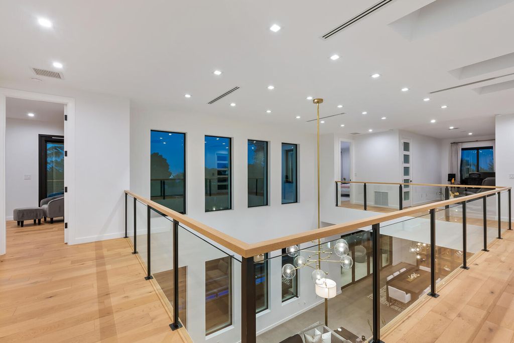 545 Kingfisher Lane, Longboat Key, Florida is a custom built modern canal front Longboat Key home with dramatic wide shell stone stair entrance, massive 60-inch ceramic tile flooring, 20-foot ceilings, skylights, lap-pool with 2 waterfall features, outdoor kitchen adjacent to indoor kitchen, and 5-car garage.